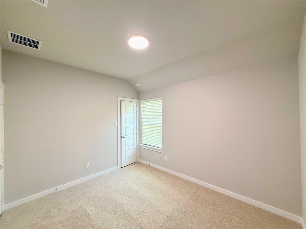 1909 Sandpiper Way Princeton, TX 75407 - Photo 18 of 35 Spare room with vaulted ceiling and light colored carpet