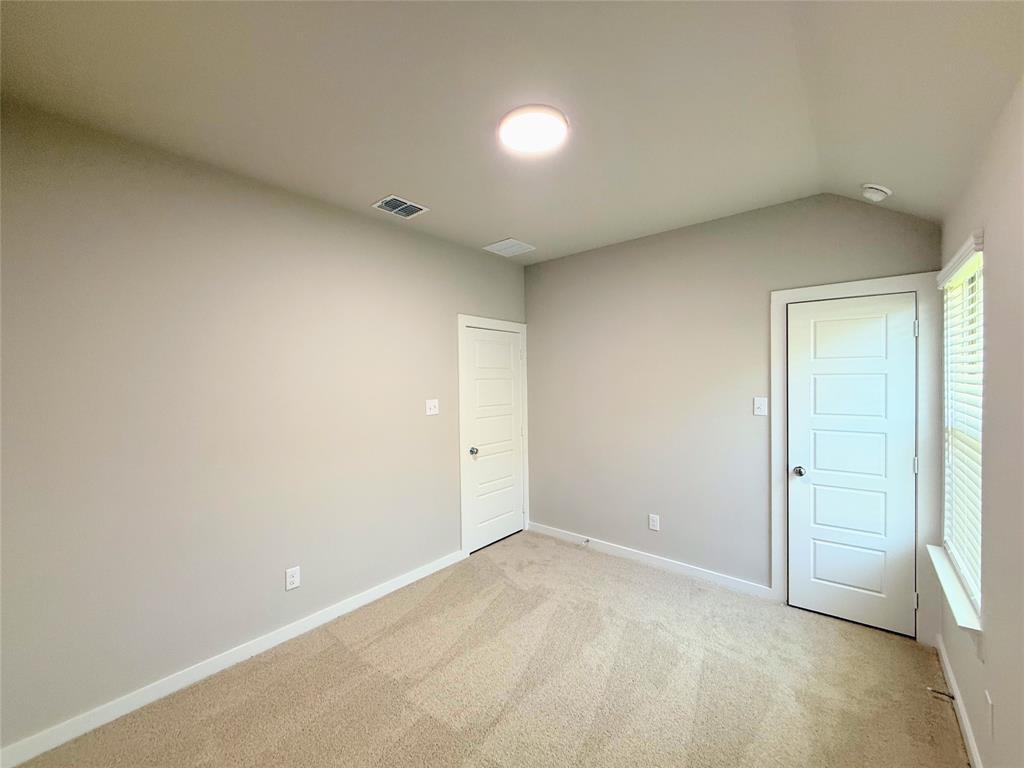 1909 Sandpiper Way Princeton, TX 75407 - Photo 19 of 35 Unfurnished bedroom with light colored carpet and vaulted ceiling