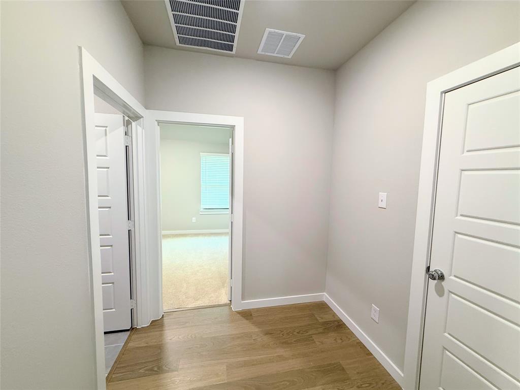 1909 Sandpiper Way Princeton, TX 75407 - Photo 20 of 35 Corridor with light wood finished floors and baseboards
