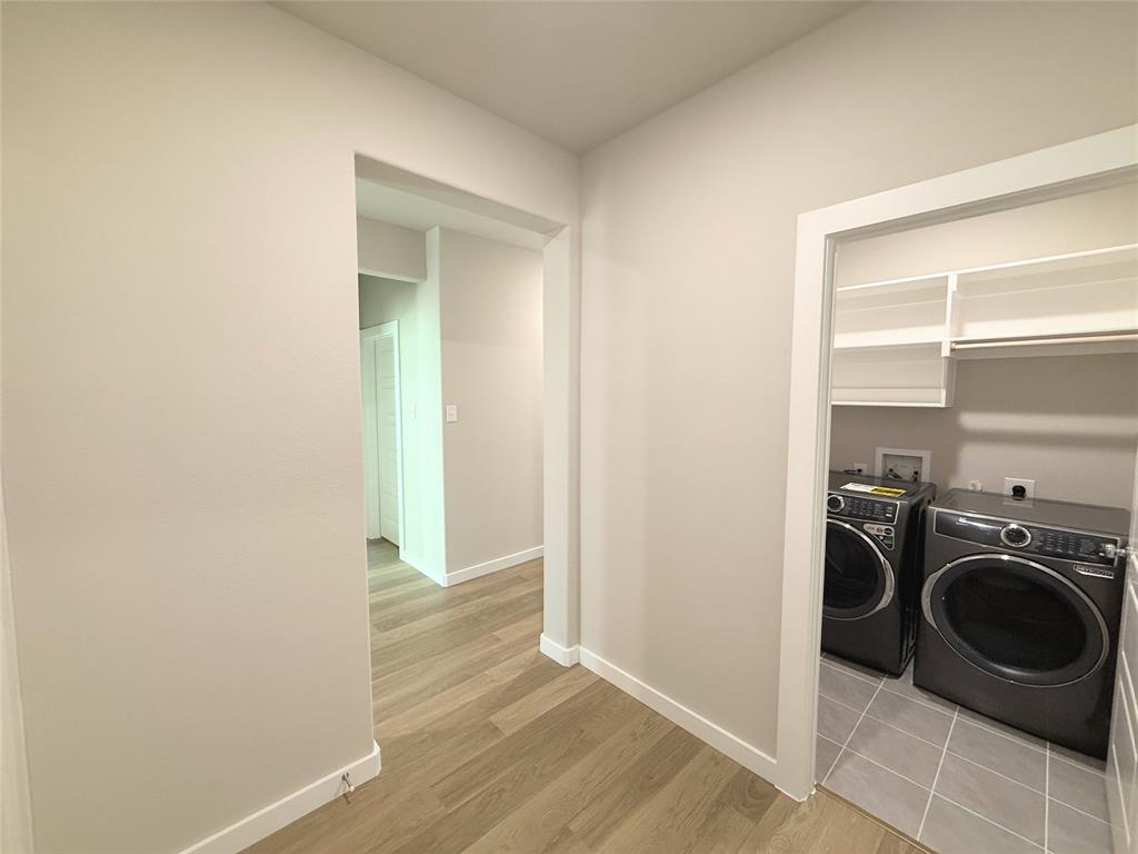 1909 Sandpiper Way Princeton, TX 75407 - Photo 21 of 35 Laundry area featuring washing machine and clothes dryer and light wood-style flooring