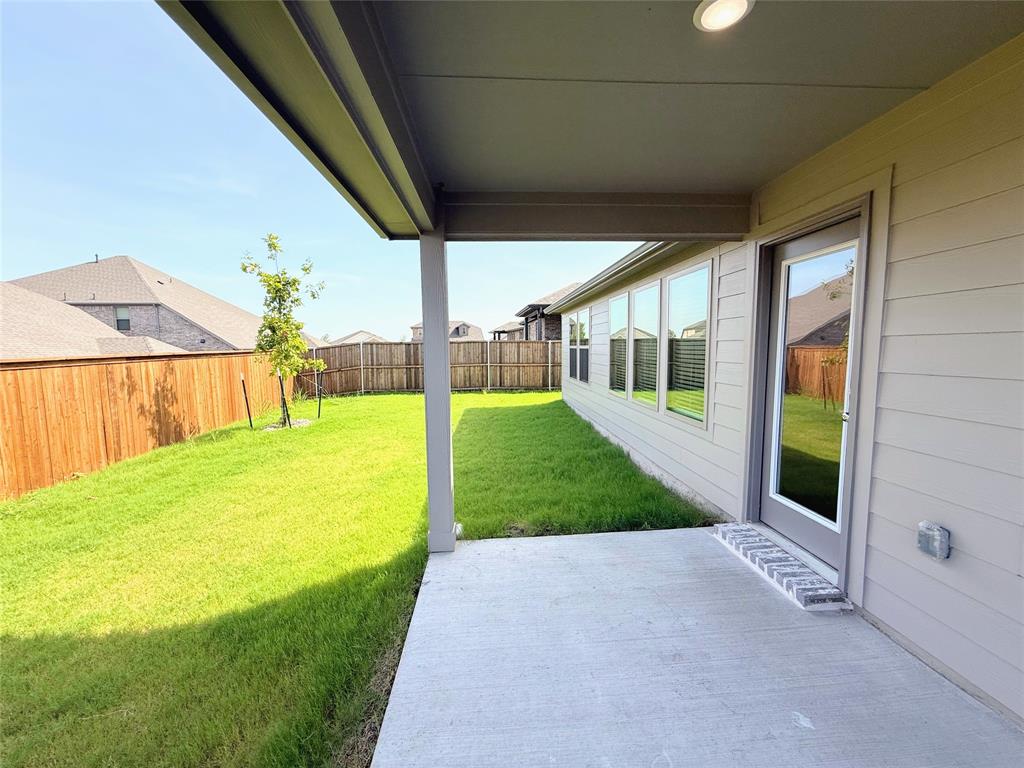 1909 Sandpiper Way Princeton, TX 75407 - Photo 29 of 35 Fenced backyard with a patio area