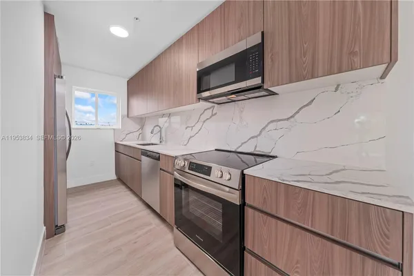 a kitchen with a stove microwave and refrigerator