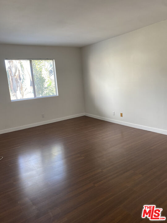 6465 Kanan Dume Road Malibu, CA 90265 - Photo 11 of 14 an empty room with wooden floor and windows