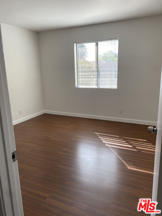 6465 Kanan Dume Road Malibu, CA 90265 - Photo 13 of 14 an empty room with wooden floor and windows