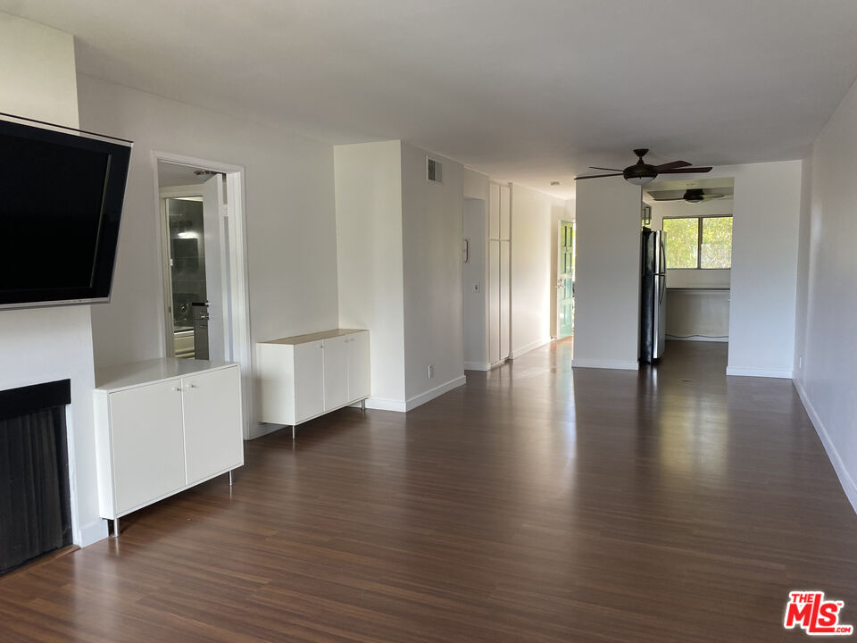 6465 Kanan Dume Road Malibu, CA 90265 - Photo 7 of 14 a view of a hallway with wooden floor and a flat screen tv