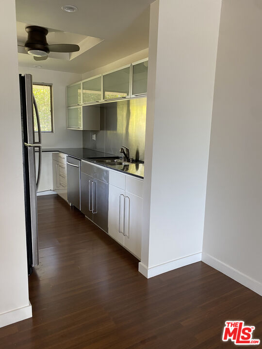 6465 Kanan Dume Road Malibu, CA 90265 - Photo 9 of 14 a kitchen with stainless steel appliances a sink and wooden floor