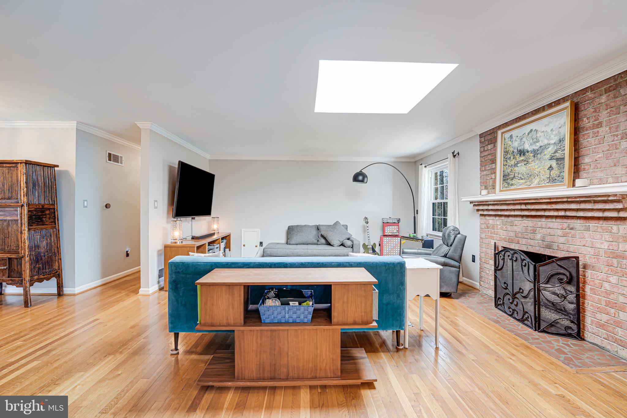 12132 Stirrup Road Reston, VA 20191 - Photo 13 of 67 a living room with furniture a fireplace and a flat screen tv