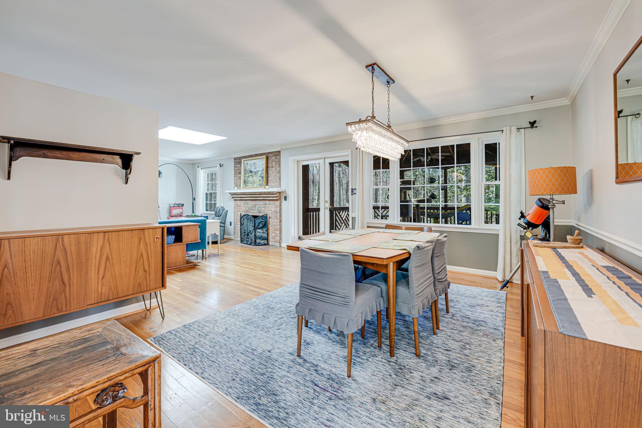 12132 Stirrup Road Reston, VA 20191 - Photo 16 of 67 a dining room with furniture a chandelier and wooden floor