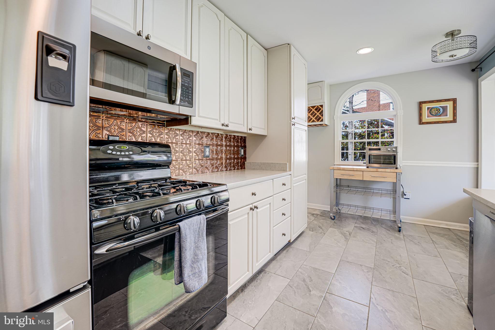 12132 Stirrup Road Reston, VA 20191 - Photo 18 of 67 a kitchen with stainless steel appliances granite countertop a stove and a refrigerator