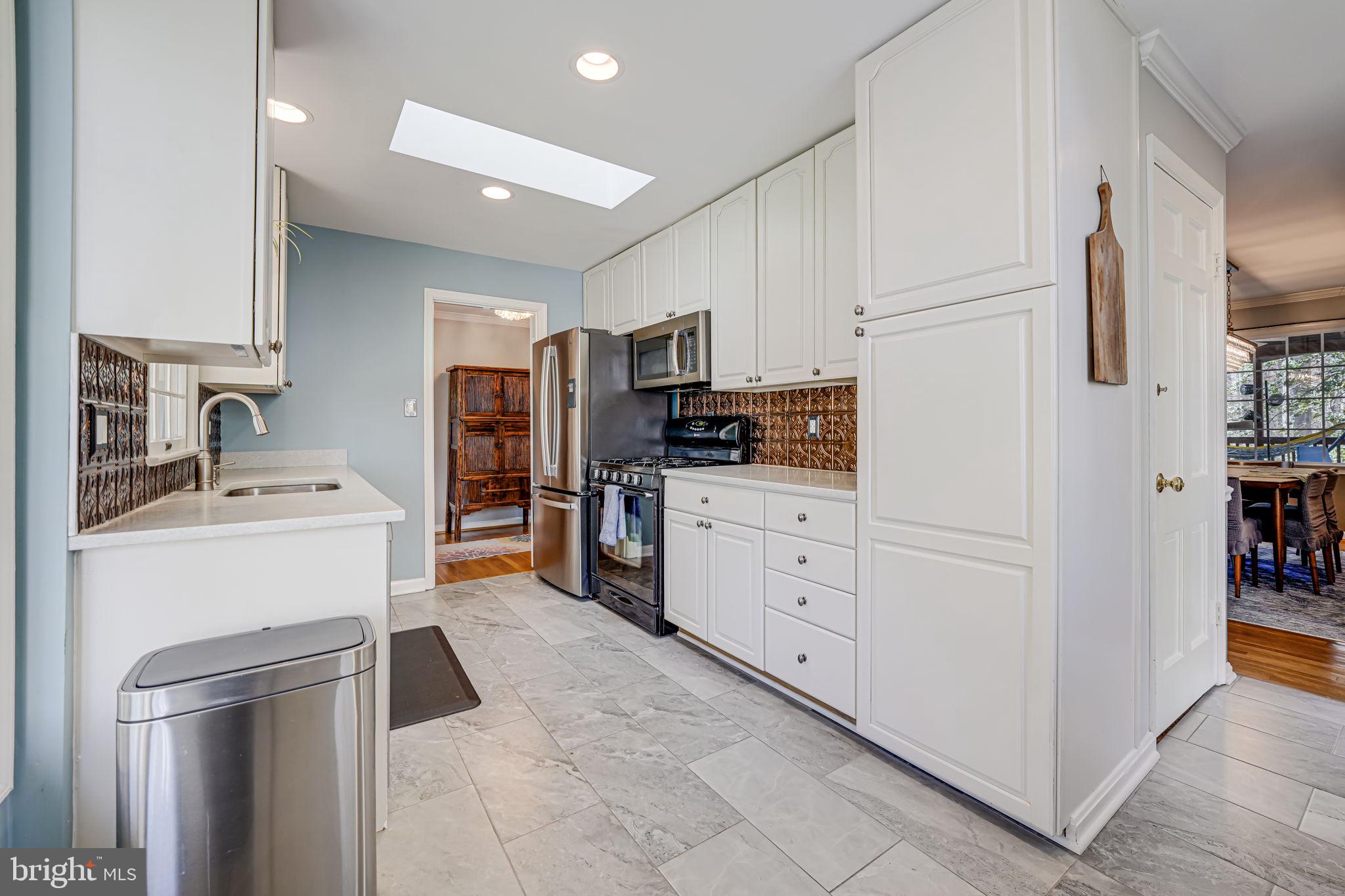 12132 Stirrup Road Reston, VA 20191 - Photo 20 of 67 a kitchen with white cabinets and stainless steel appliances