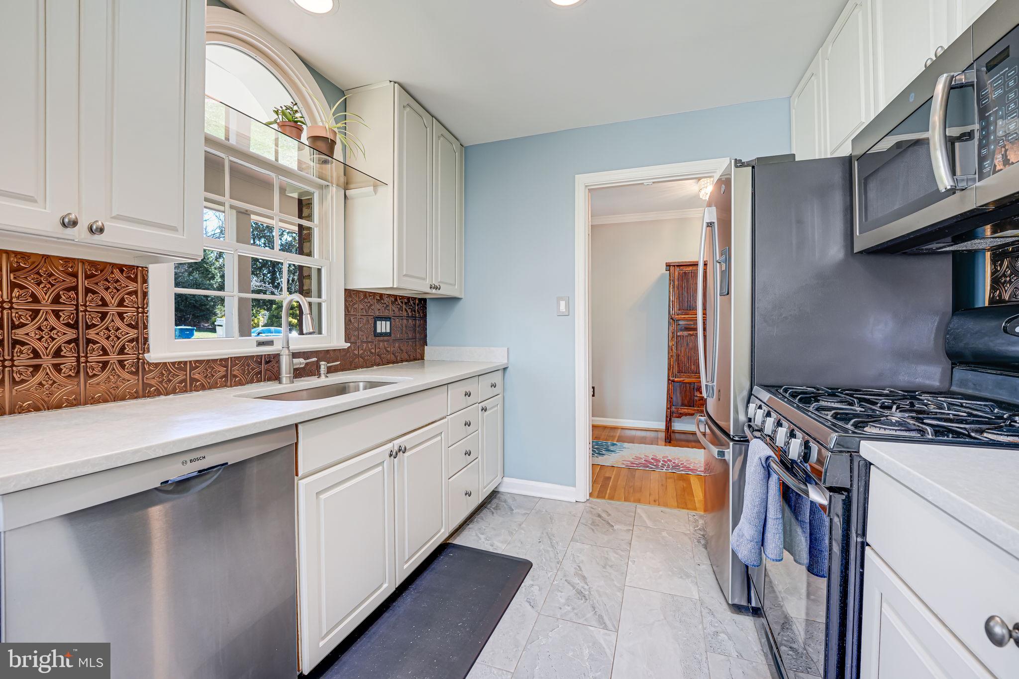 12132 Stirrup Road Reston, VA 20191 - Photo 21 of 67 a kitchen with stainless steel appliances granite countertop a stove and a sink