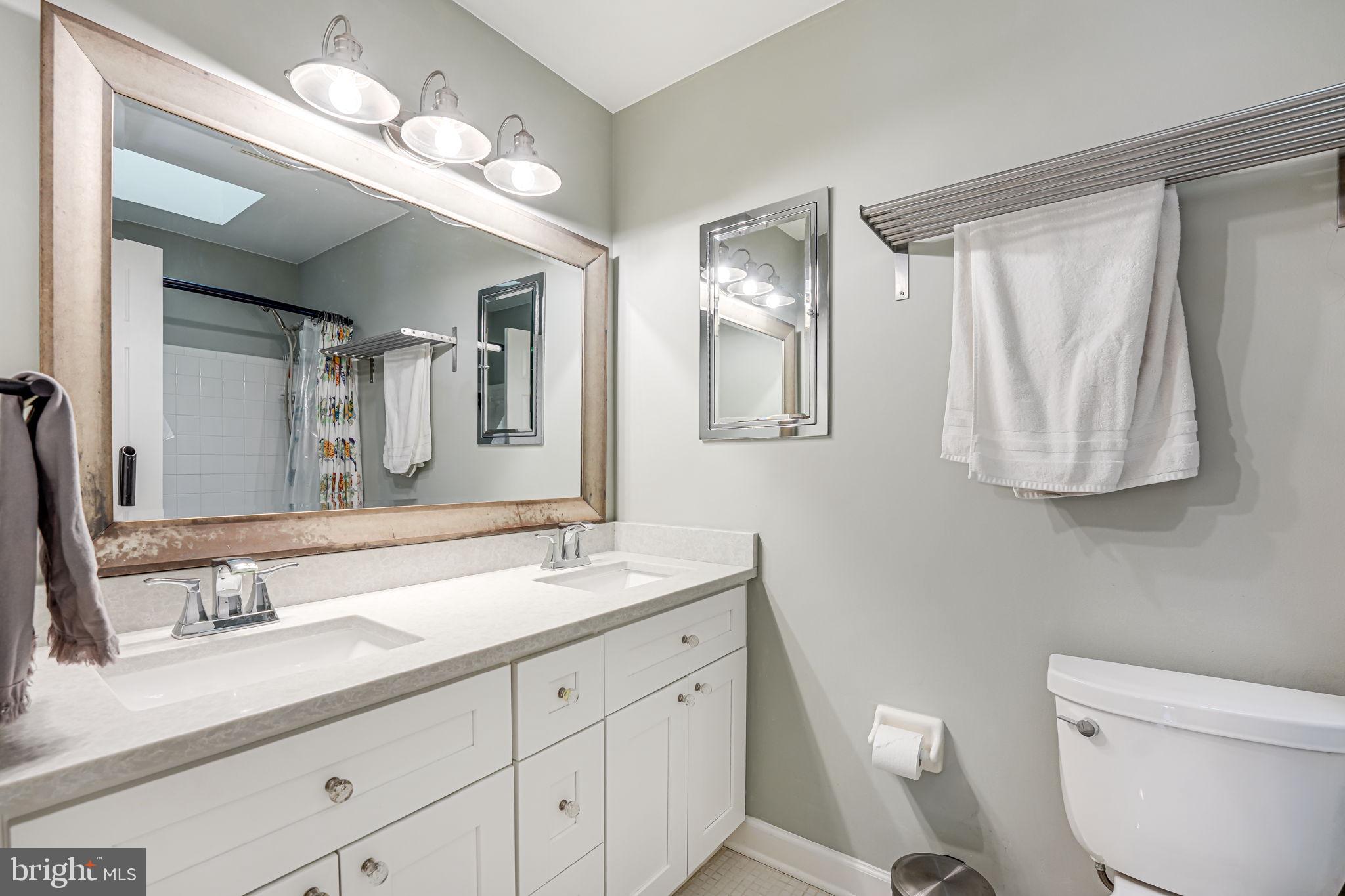 12132 Stirrup Road Reston, VA 20191 - Photo 25 of 67 a bathroom with a double vanity sink and a mirror