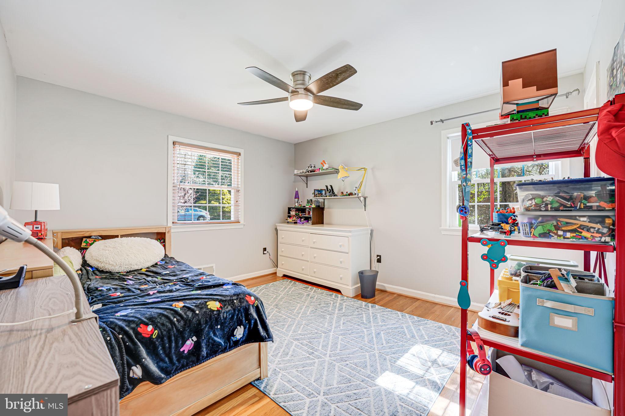 12132 Stirrup Road Reston, VA 20191 - Photo 27 of 67 a bedroom with a bed and wooden floor