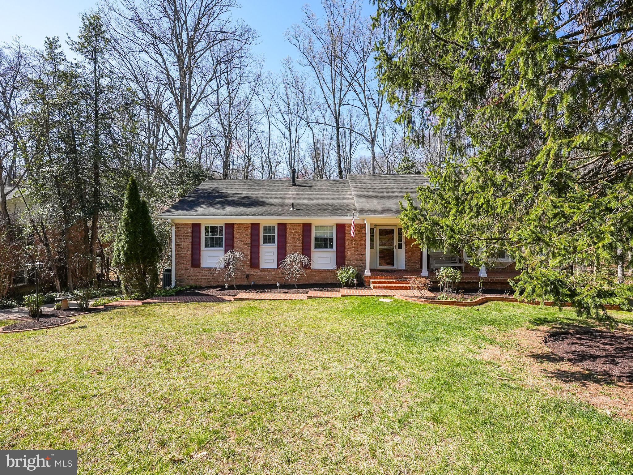 12132 Stirrup Road Reston, VA 20191 - Photo 3 of 67 a view of a house with a big yard and large trees