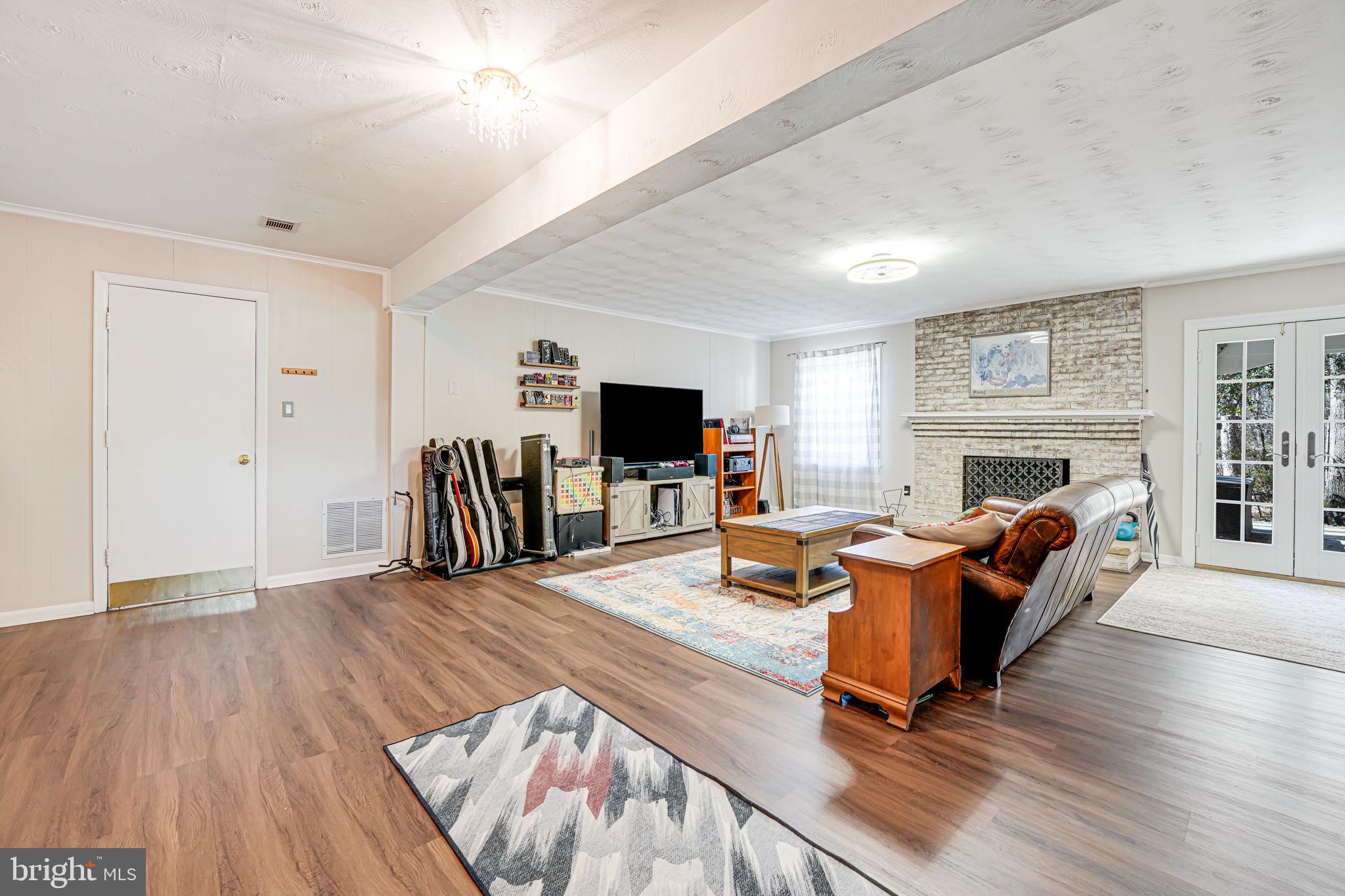 12132 Stirrup Road Reston, VA 20191 - Photo 32 of 67 a living room with furniture fireplace and flat screen tv