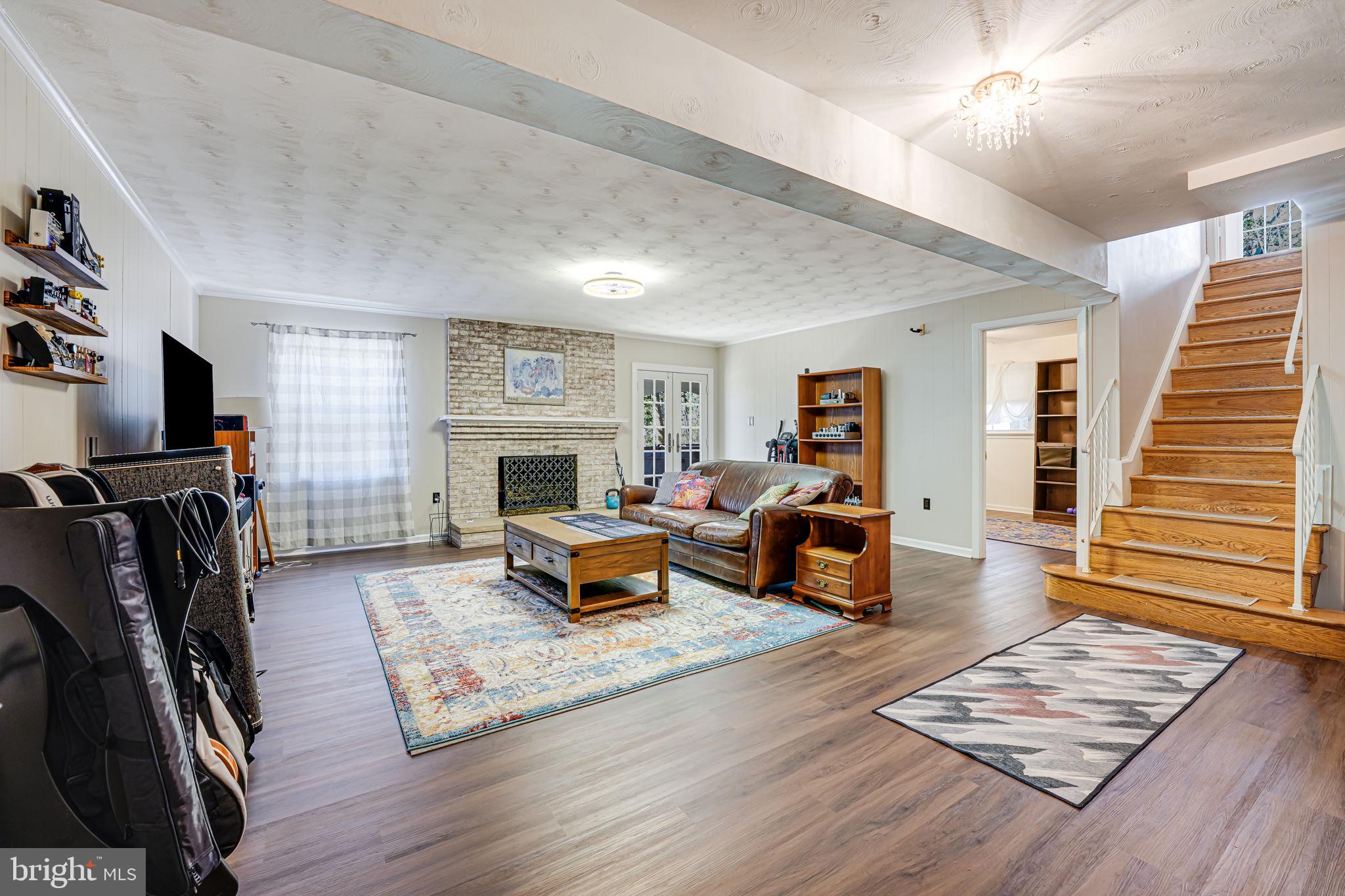 12132 Stirrup Road Reston, VA 20191 - Photo 33 of 67 a living room with furniture and a wooden floor