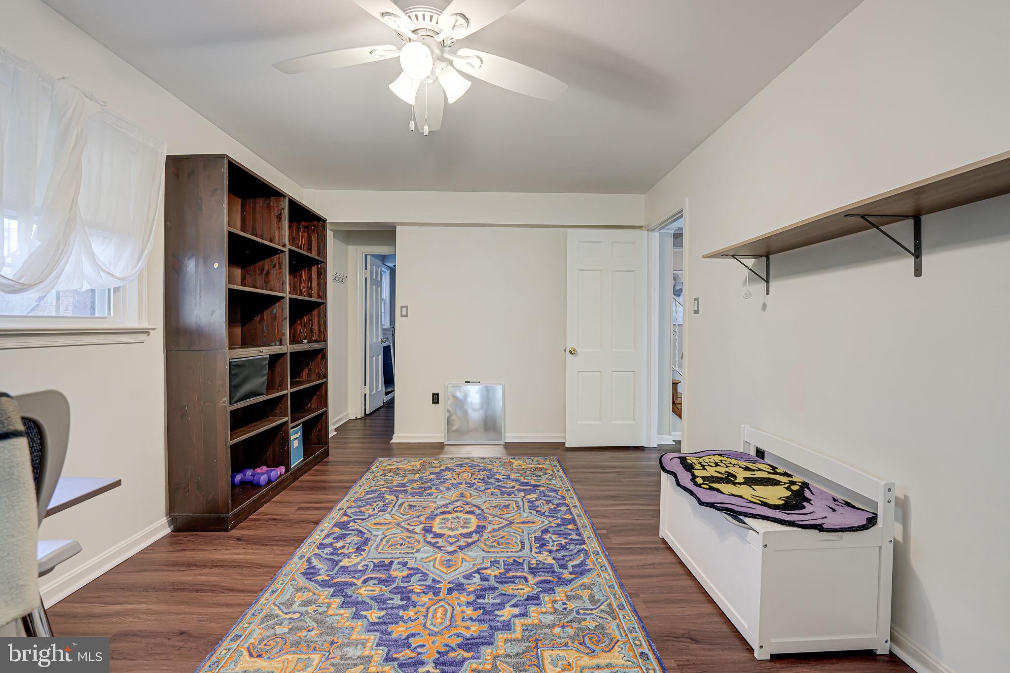 12132 Stirrup Road Reston, VA 20191 - Photo 36 of 67 a living room with a couch and a bookshelf