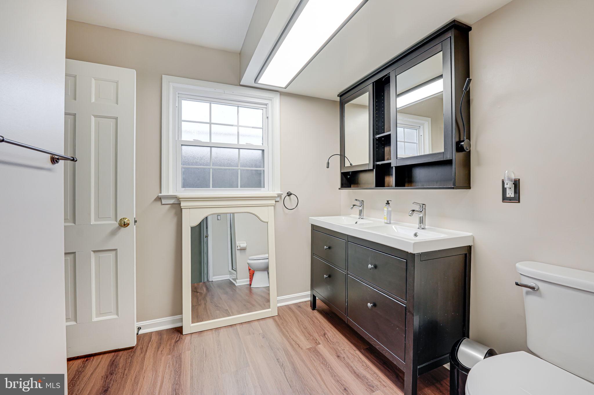 12132 Stirrup Road Reston, VA 20191 - Photo 37 of 67 a spacious bathroom with a double vanity sink a mirror and a toilet