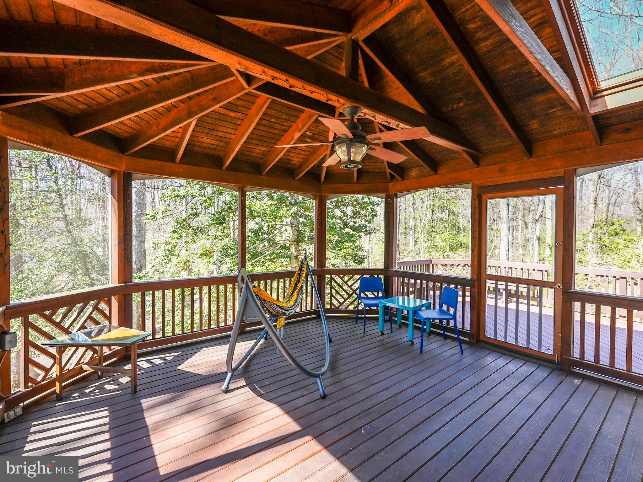 12132 Stirrup Road Reston, VA 20191 - Photo 44 of 67 a view of a patio with wooden floor a yard tables and chairs