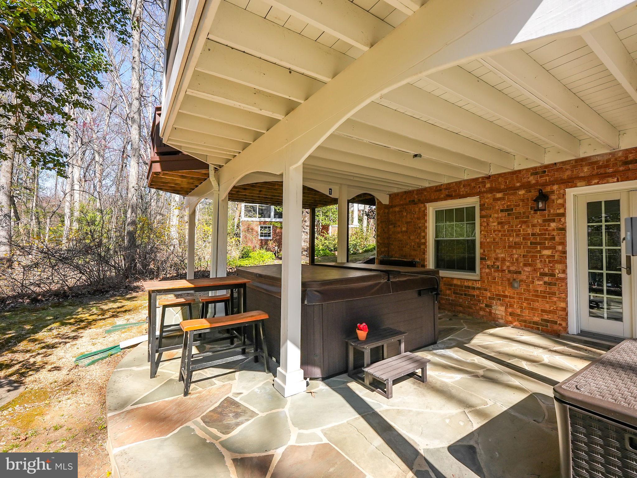 12132 Stirrup Road Reston, VA 20191 - Photo 54 of 67 a view of a patio with table and chairs with wooden floor and fence