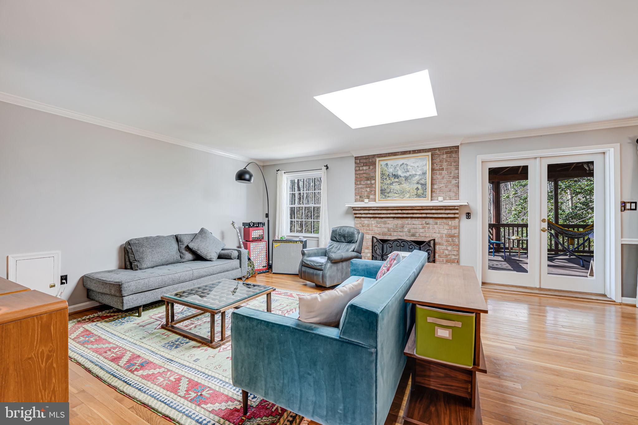 12132 Stirrup Road Reston, VA 20191 - Photo 10 of 67 a living room with furniture a fireplace and wooden floor