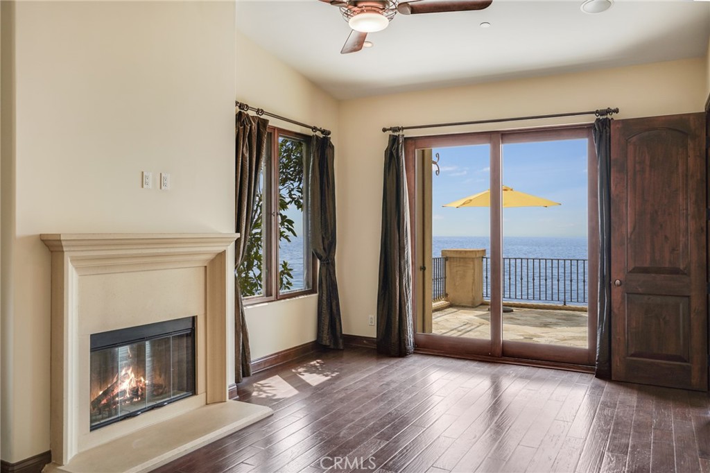 2320 Crestview Drive Laguna Beach, CA 92651 - Photo 13 of 28 a view of an empty room with wooden floor fireplace and a window