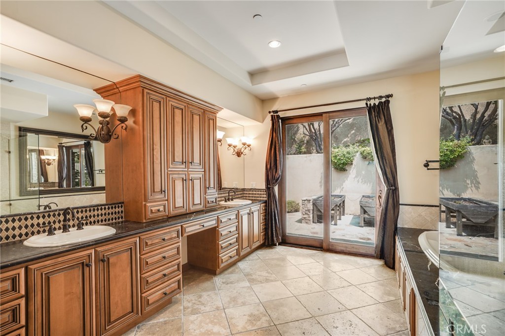 2320 Crestview Drive Laguna Beach, CA 92651 - Photo 14 of 28 a spacious bathroom with a granite countertop tub sink a mirror a next to a window