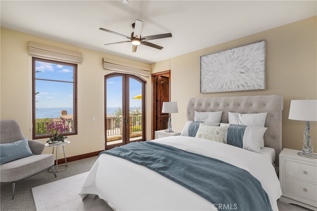 2320 Crestview Drive Laguna Beach, CA 92651 - Photo 17 of 28 a bedroom with a large bed and a chandelier