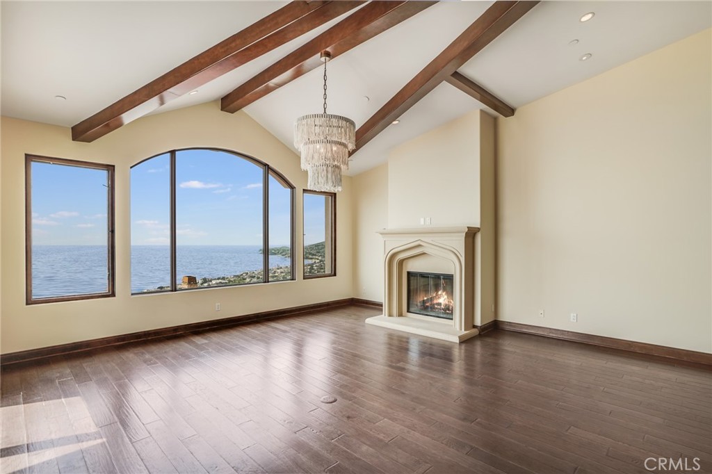 2320 Crestview Drive Laguna Beach, CA 92651 - Photo 4 of 28 a view of an empty room with a fireplace and a window