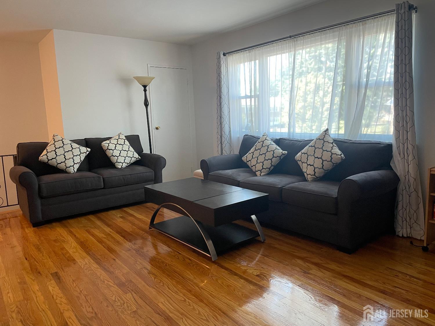 182 Evergreen Road, Unit 3B Edison, NJ 08837 - Photo 6 of 9 a living room with furniture and a window