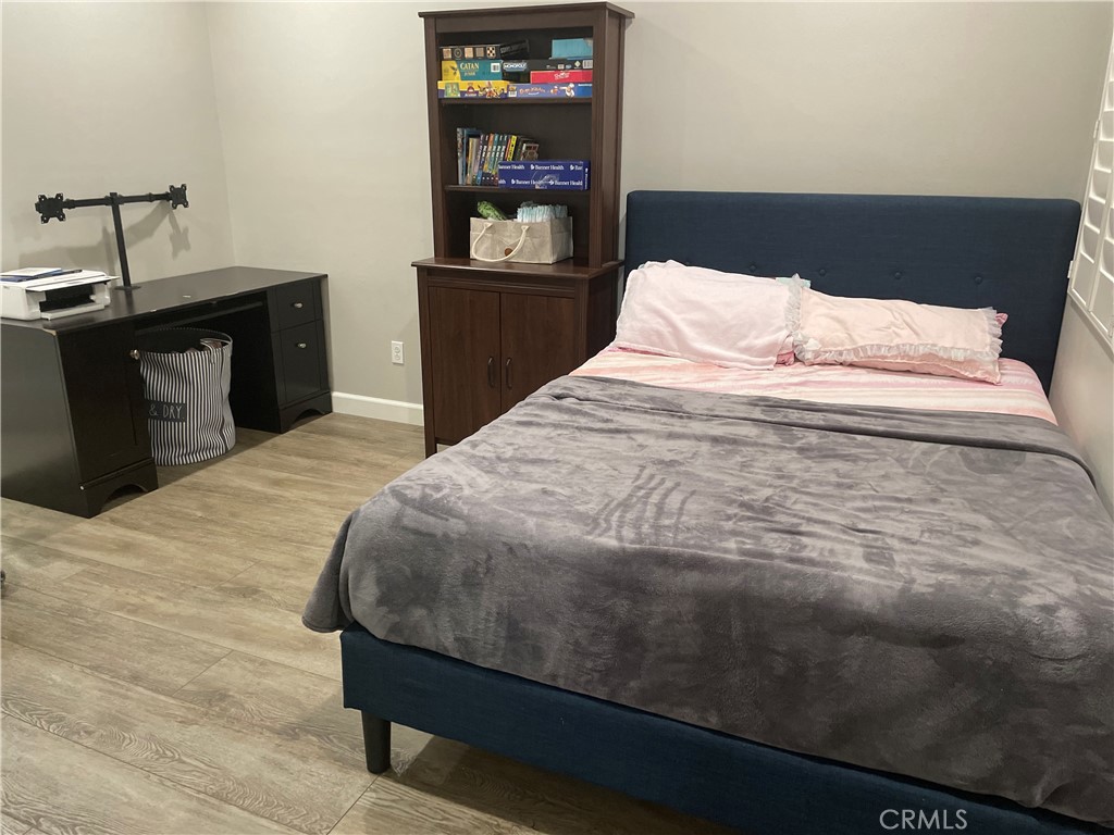 1563 Silver Shadow Drive Thousand Oaks, CA 91320 - Photo 11 of 24 a bedroom with a bed and wooden floor