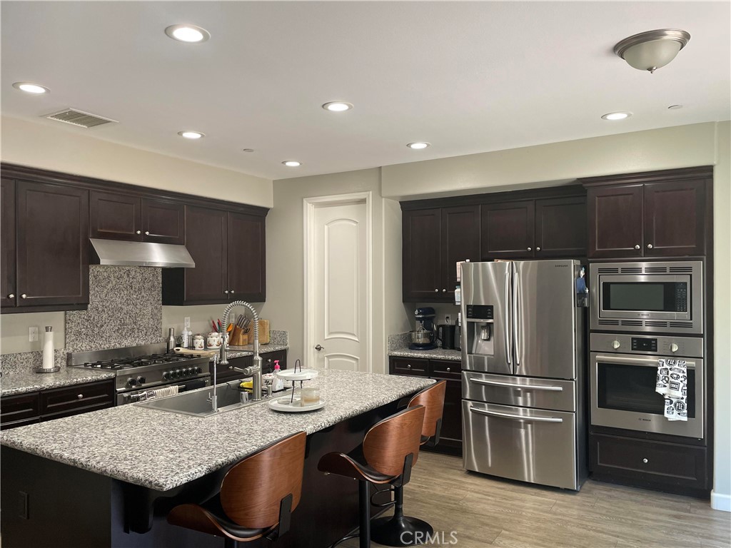 1563 Silver Shadow Drive Thousand Oaks, CA 91320 - Photo 12 of 24 a kitchen with refrigerator and stove