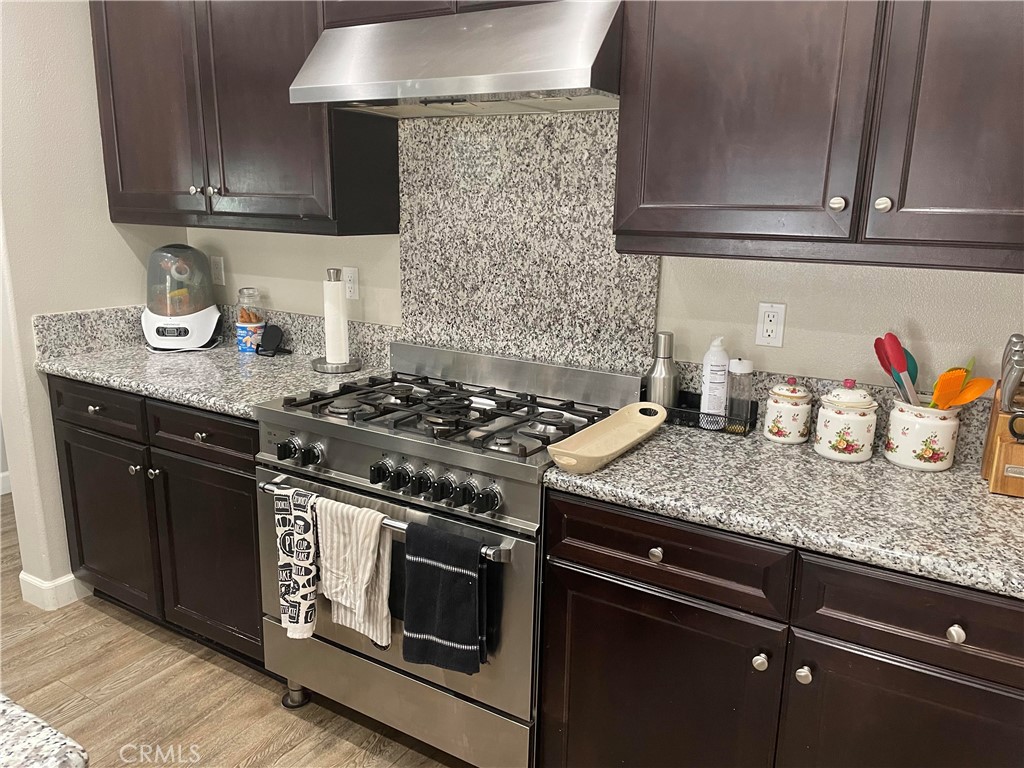 1563 Silver Shadow Drive Thousand Oaks, CA 91320 - Photo 14 of 24 a kitchen with granite countertop stainless steel appliances and wooden cabinets