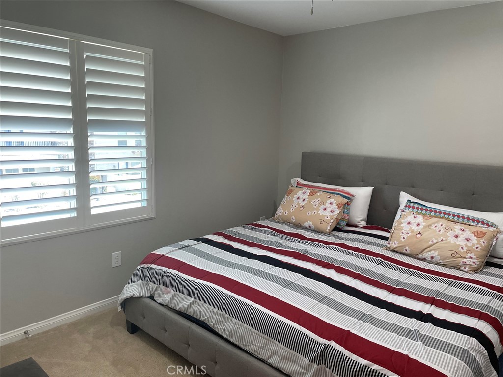 1563 Silver Shadow Drive Thousand Oaks, CA 91320 - Photo 9 of 24 a bed sitting in a bedroom next to a window