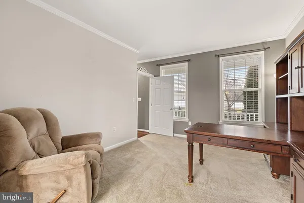 a workspace room with furniture and windows