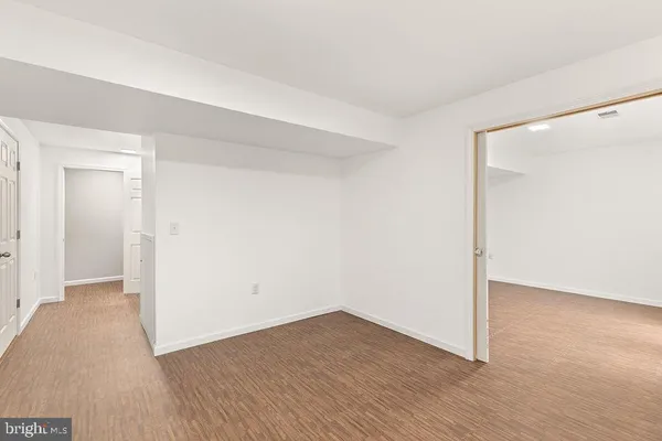 a view of a room with wooden floor and windows
