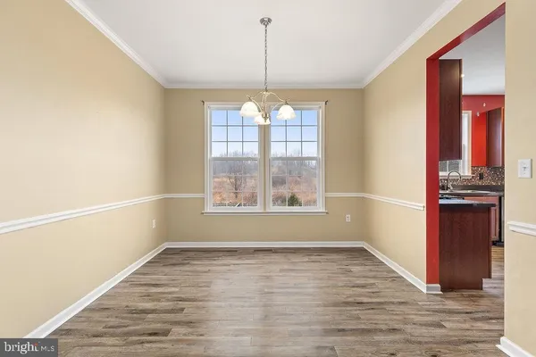 a view of a room with window and wooden floor