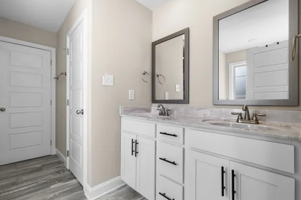 a bathroom with a double vanity sink mirror and