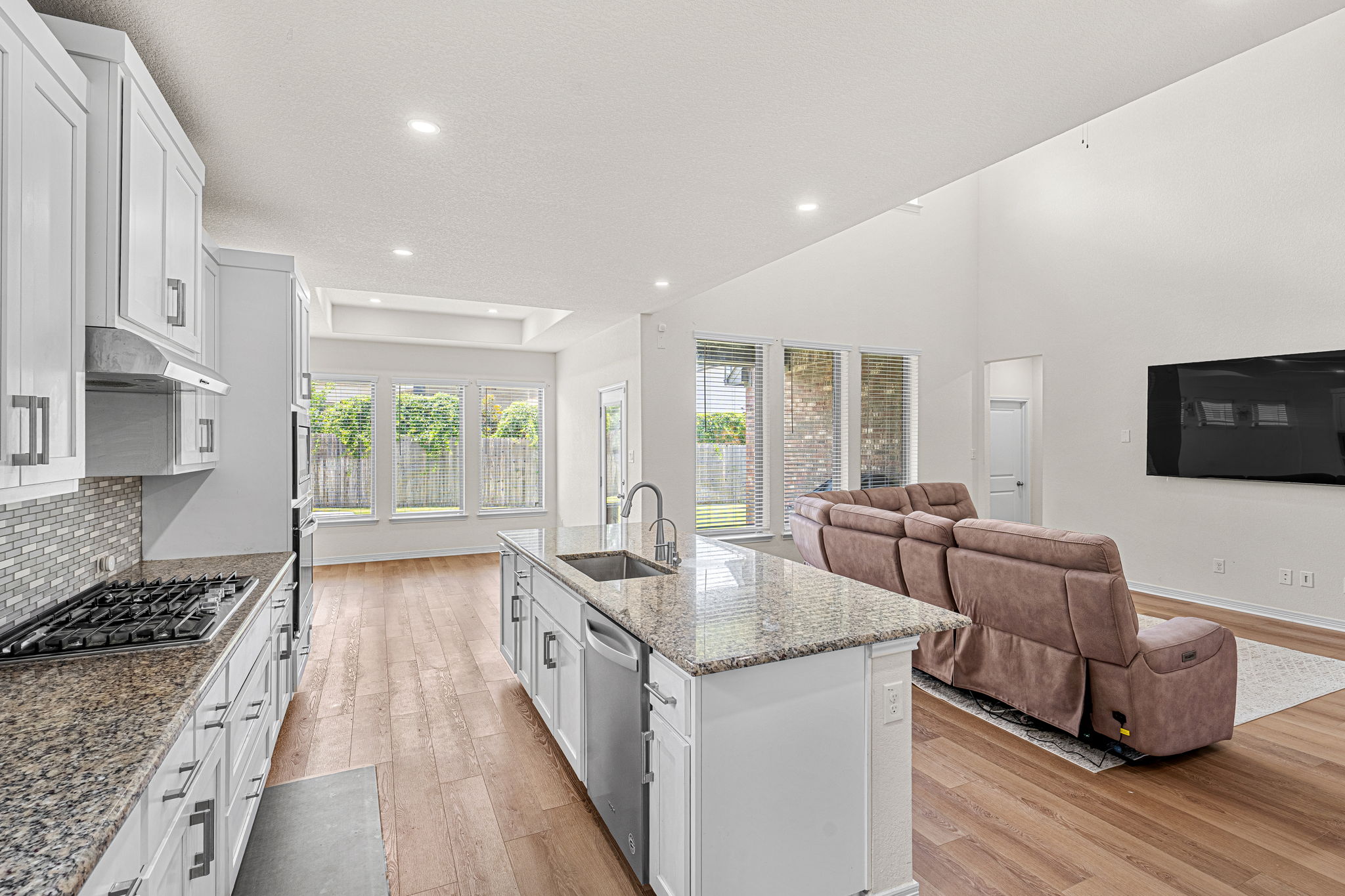20813 Carries Ranch Road Pflugerville, TX 78660 - Photo 10 of 40 Gleaming stone countertops and warm wood floors define this soaring, light-filled open concept space.