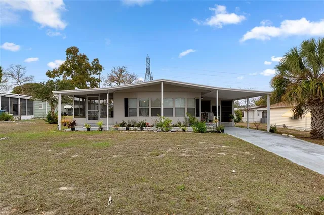 a front view of a house with a garden and patio