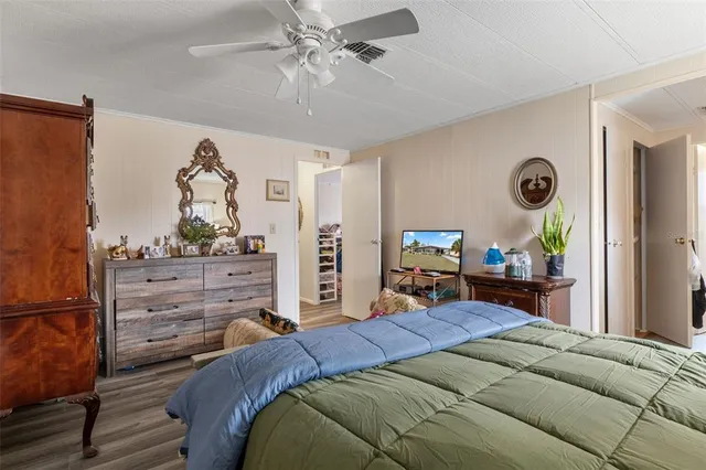 a bed room with a bed mirror and a window