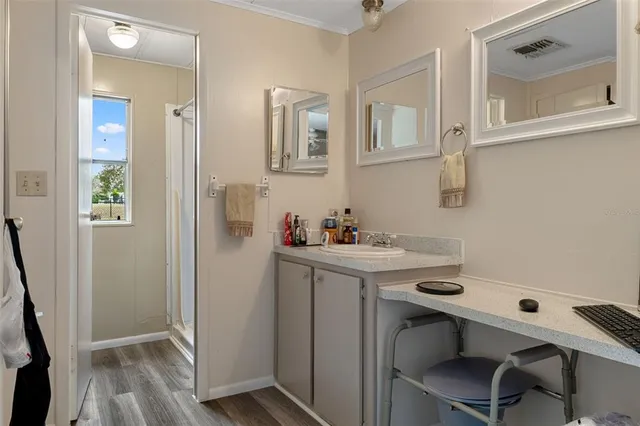 a view of a bathroom with sink and mirror