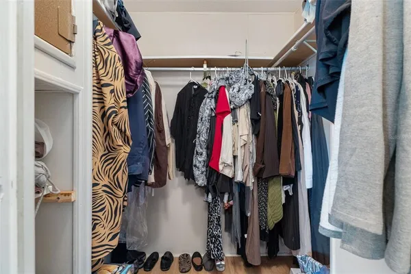 a view of walk in closet with clothes