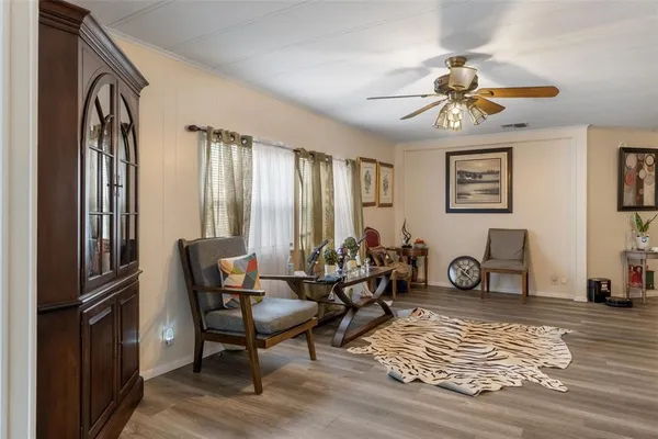 a living room with furniture a fireplace and a window