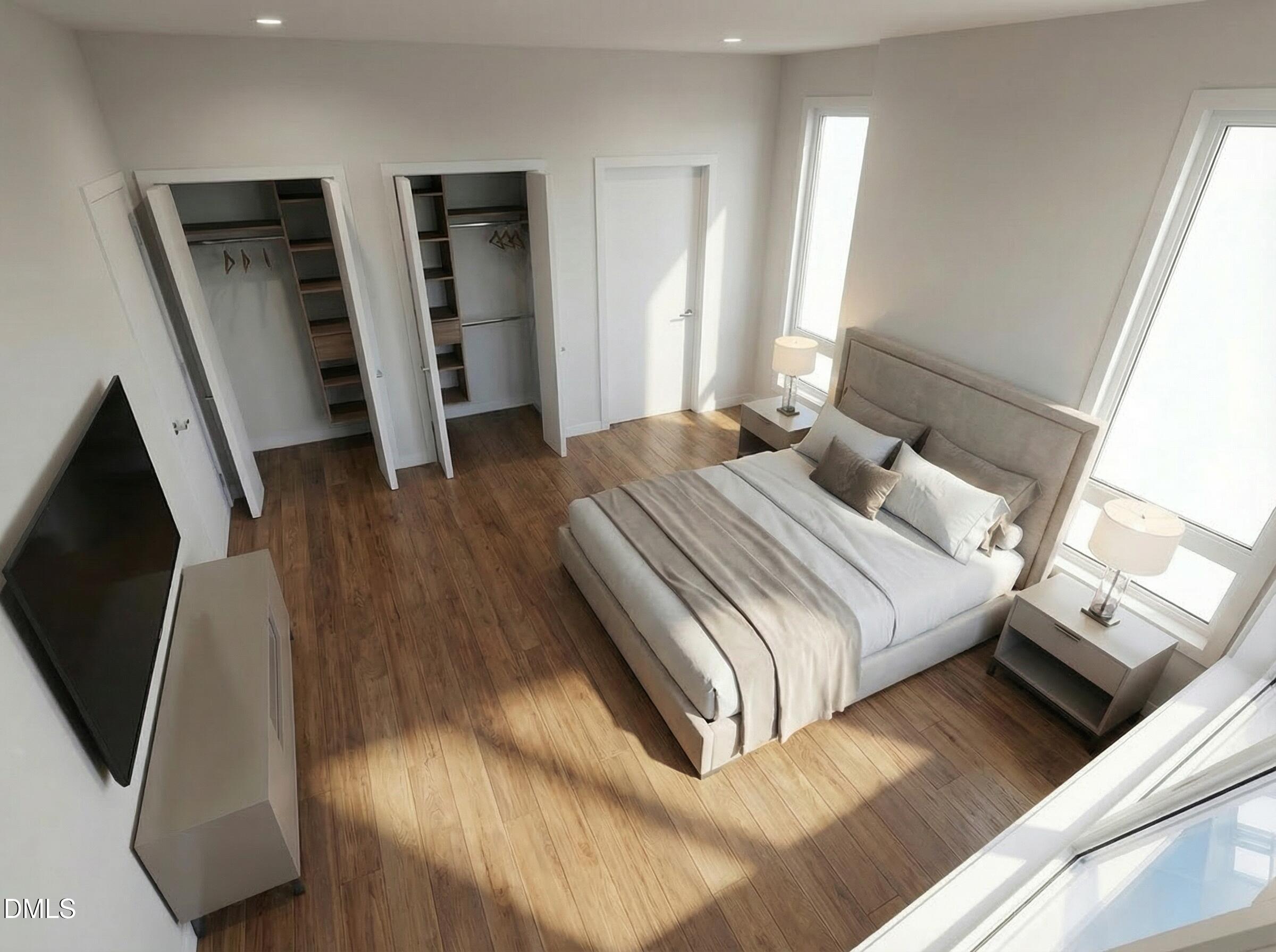 1222 Merrick Street Durham, NC 27707 - Photo 5 of 13 a bedroom with a bed and a flat screen tv