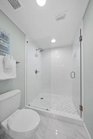 a view of a large building with a big yard and large trees