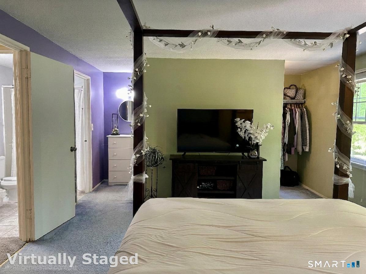 2 Lakeside Drive, Unit M Ledyard, CT 06339 - Photo 22 of 38 a bedroom with a bed and a flat tv screen