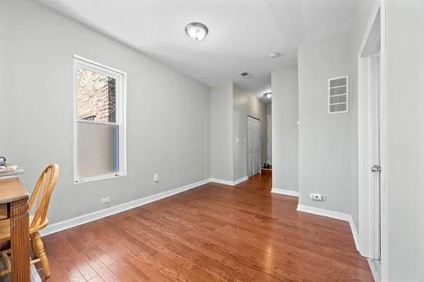 a living room with furniture and view of kitchen