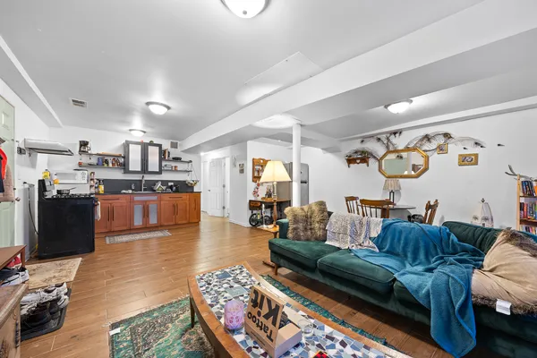 a living room with furniture and a gym machine