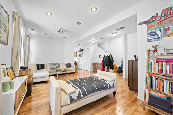 a living room with furniture and wooden floor